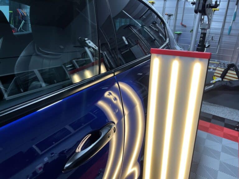 Blue Car Door Panel PDR Assessment — RPM Dent Repair Raynham MA Blue car door panel PDR light assessment before paintless dent repair at RPM Dent Repair Raynham Massachusetts