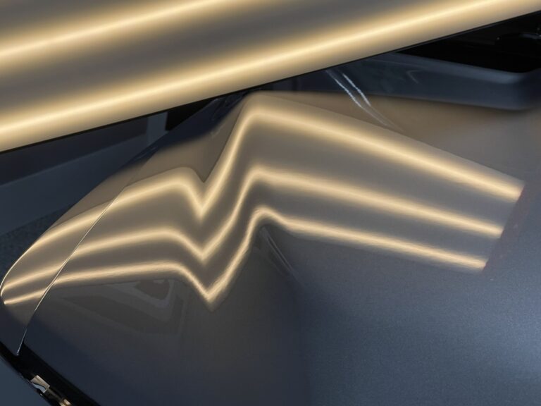 Vehicle body panel with collision or impact dent before PDR repair in Raynham MA