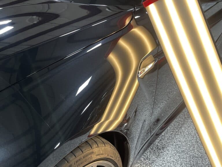 Large dent on vehicle body panel before paintless dent repair near Boston MA