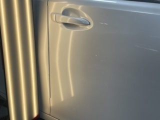 Crease Dent Repair — Long Body Panel Crease Before PDR Long crease dent running across vehicle body panel before paintless dent repair in Raynham MA
