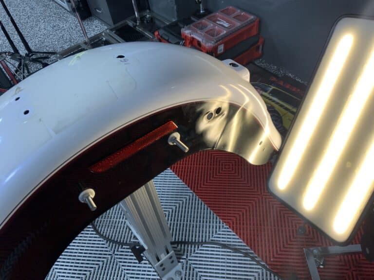 Motorcycle Rear Fender PDR — Panel Off the Bike, Raynham MA Motorcycle rear fender removed from the bike and set on a stand for paintless dent repair at RPM Dent Repair Raynham Massachusetts
