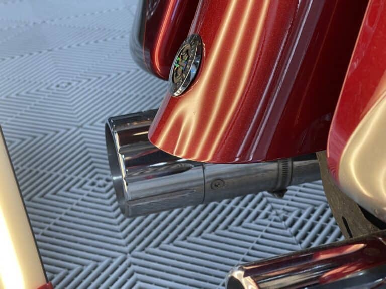 Motorcycle Saddlebag Dent Repair — RPM Dent Repair Raynham MA Dent on the red saddlebag of a touring motorcycle under PDR light at RPM Dent Repair Raynham Massachusetts