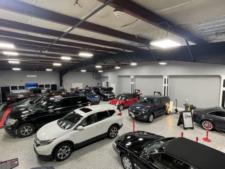 RPM Dent Repair Professional PDR Shop — Raynham Massachusetts Interior of RPM Dent Repair professional PDR shop in Raynham Massachusetts showing multiple vehicles being repaired