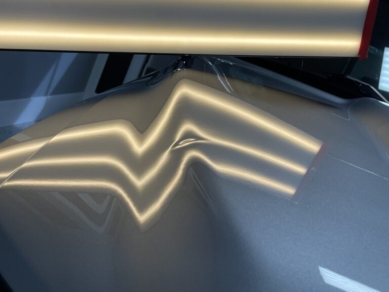 Sharp Crease Dent Along a Body Line — PDR Raynham MA Sharp crease dent following the body line of a silver vehicle panel under PDR light at RPM Dent Repair Raynham Massachusetts