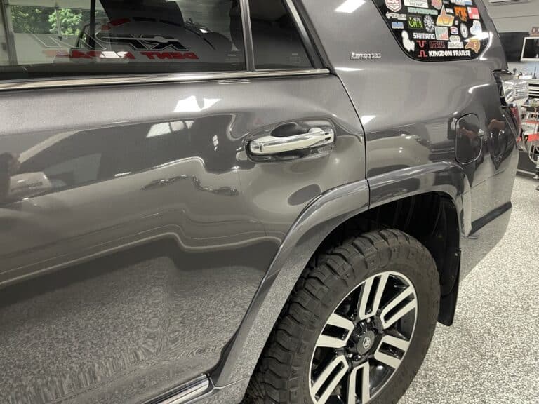SUV Body-Side Dent Assessment — PDR Raynham MA Dent along the body side of a dark grey SUV under PDR light assessment at RPM Dent Repair Raynham Massachusetts