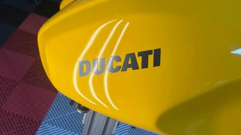 Ducati motorcycle fuel tank fully restored after paintless dent repair &mdash; no paint