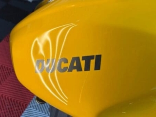Ducati motorcycle fuel tank with dent before paintless dent repair
