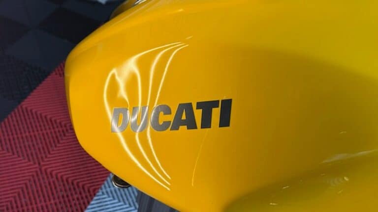 Ducati motorcycle fuel tank with dent before paintless dent repair